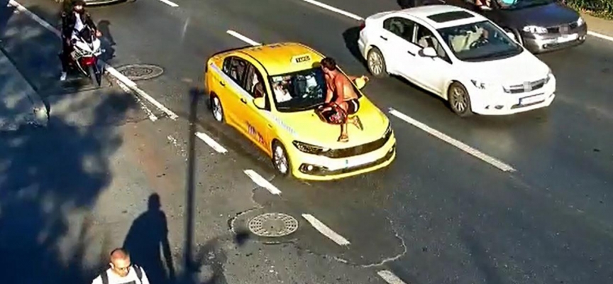 Tartıştığı taksiciyi durdurmak için kaputun üzerine çıktı